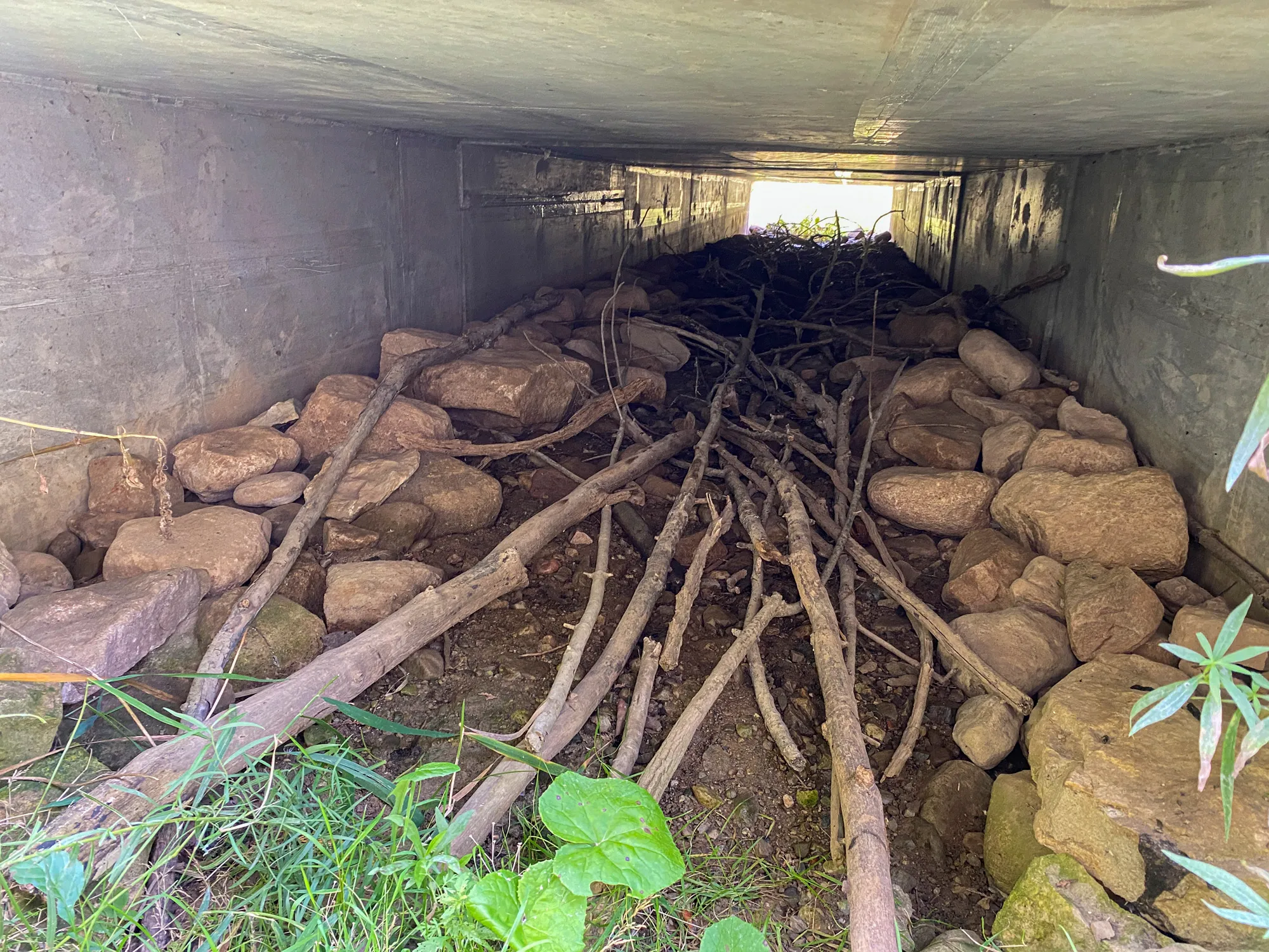 Winston Churchill Boulevard - view through a large culvert with rocks and trees